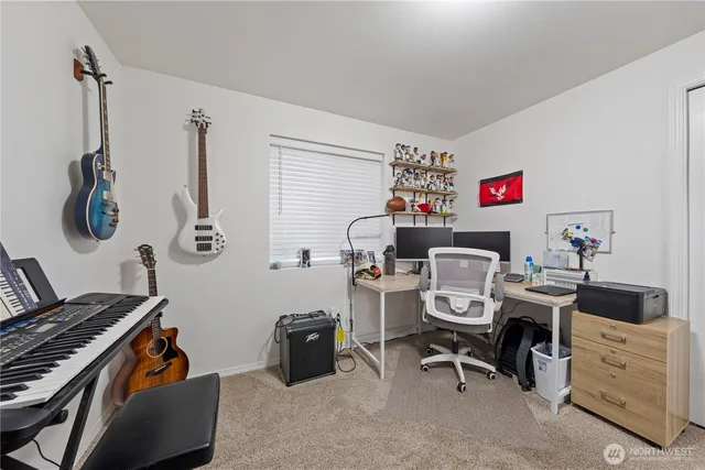 a room with a workspace and a window