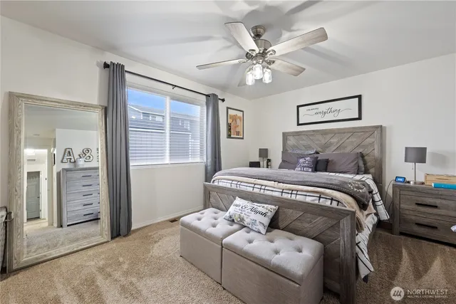 a bedroom with a large bed and a chandelier