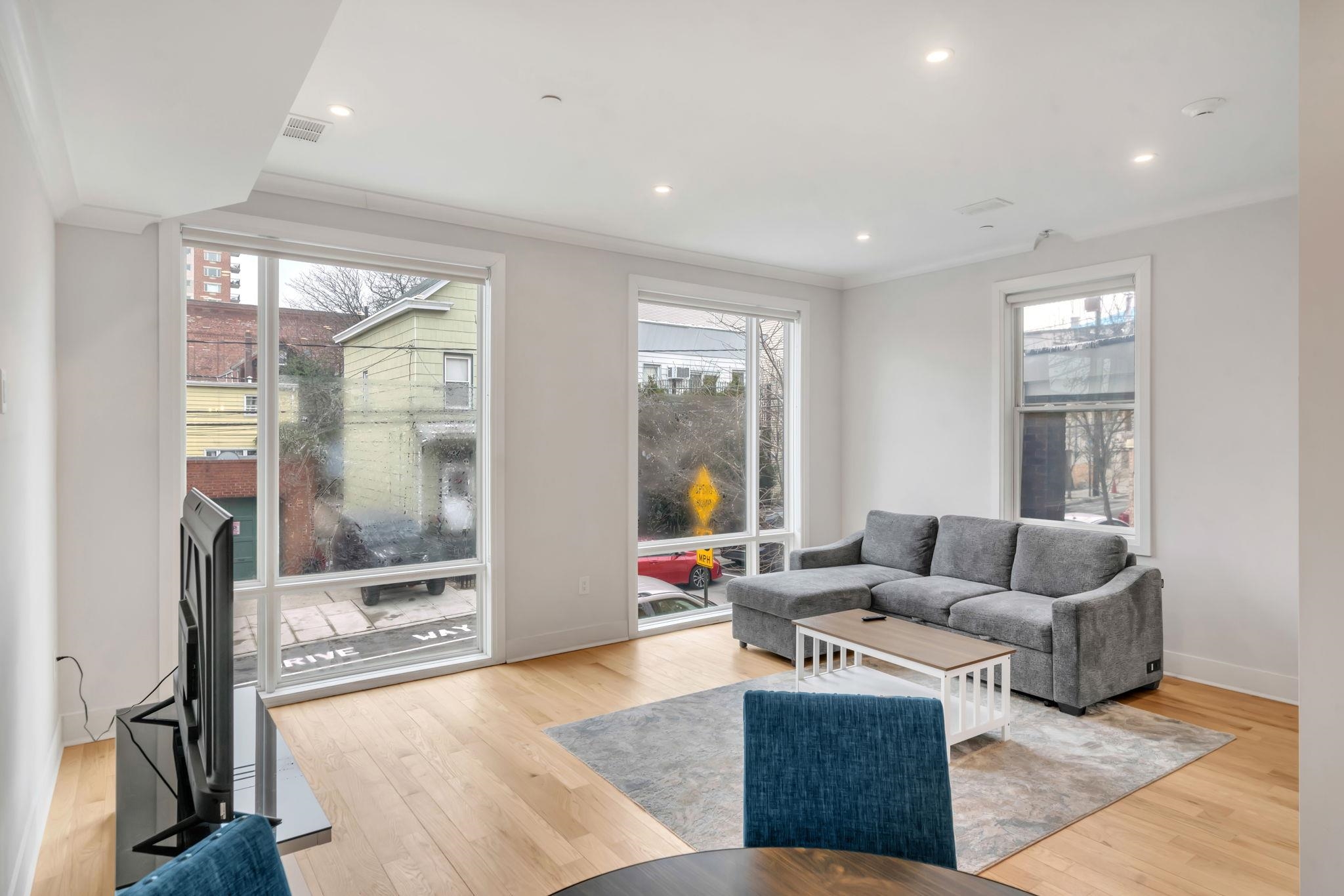 136 35th Street, Unit 1 Union City, NJ 07087 - Photo 3 of 18 a living room with furniture and a large window
