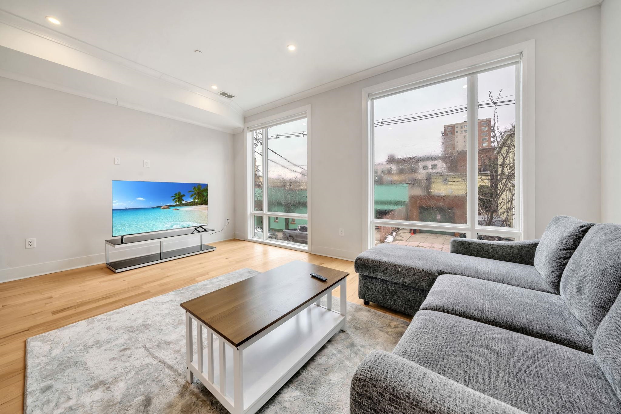 136 35th Street, Unit 1 Union City, NJ 07087 - Photo 4 of 18 a living room with furniture and a flat screen tv