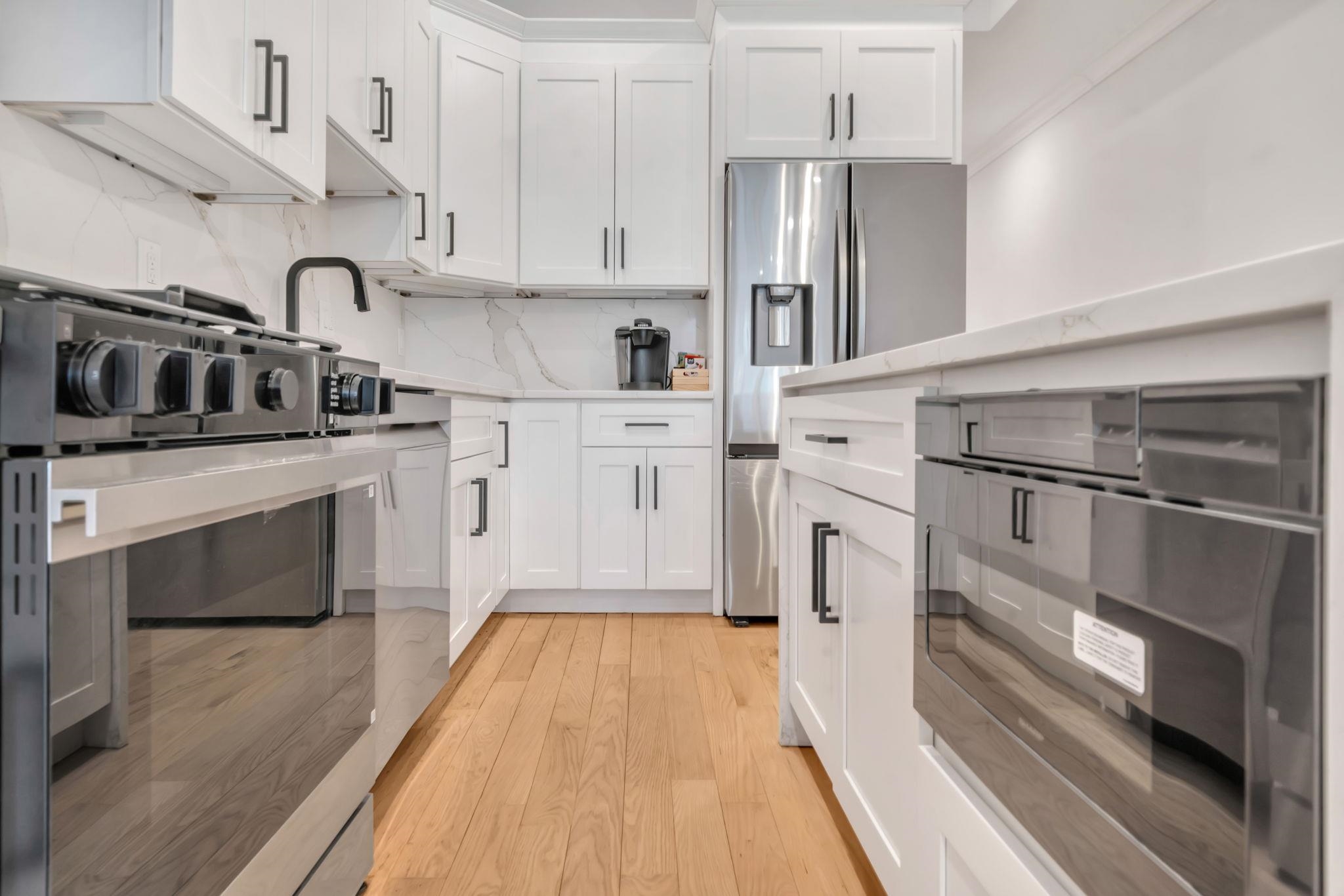 136 35th Street, Unit 1 Union City, NJ 07087 - Photo 7 of 18 a kitchen with stainless steel appliances granite countertop a stove a sink and a refrigerator