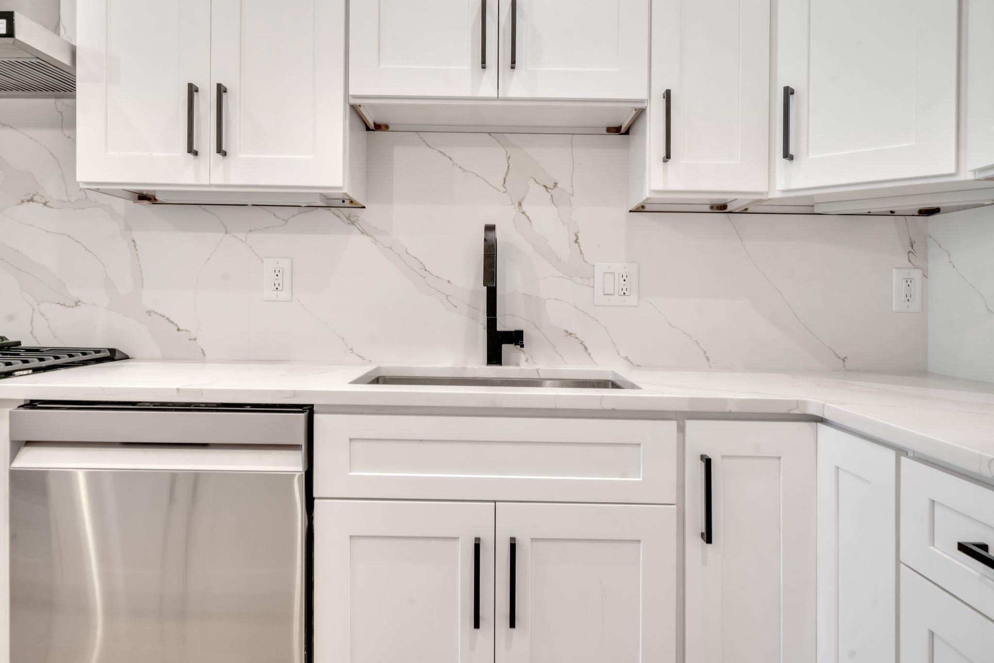 136 35th Street, Unit 1 Union City, NJ 07087 - Photo 9 of 18 a close view of a sink and a cabinet in a kitchen