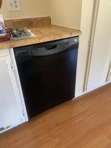 a view of kitchen and an empty room