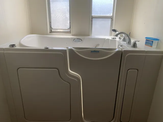 a bathroom with a sink and a washer dryer