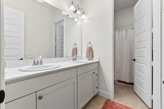 a bathroom with a double vanity sink and a mirror