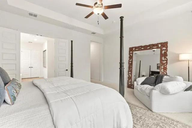 a bedroom with a bed and ceiling fan