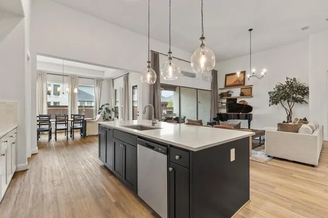 a kitchen with sink and refrigerator