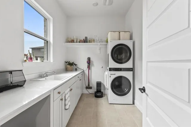 a utility room with sink dryer and washer