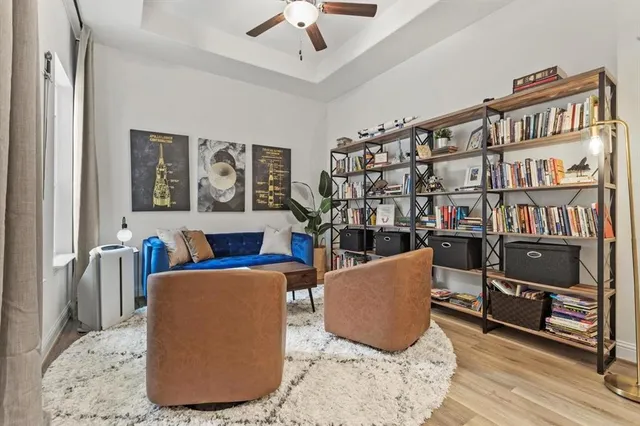 a living room with furniture and a book shelf