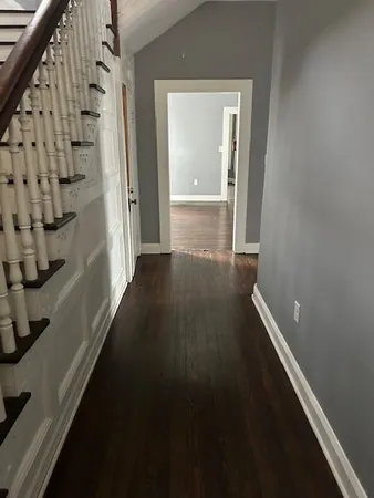a view of an entryway with wooden floor