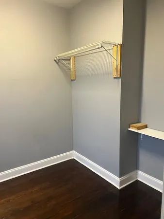 a view of a room with wooden floor