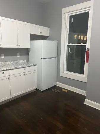 a kitchen with a refrigerator and window
