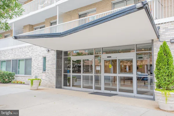 a front view of a building with a garden