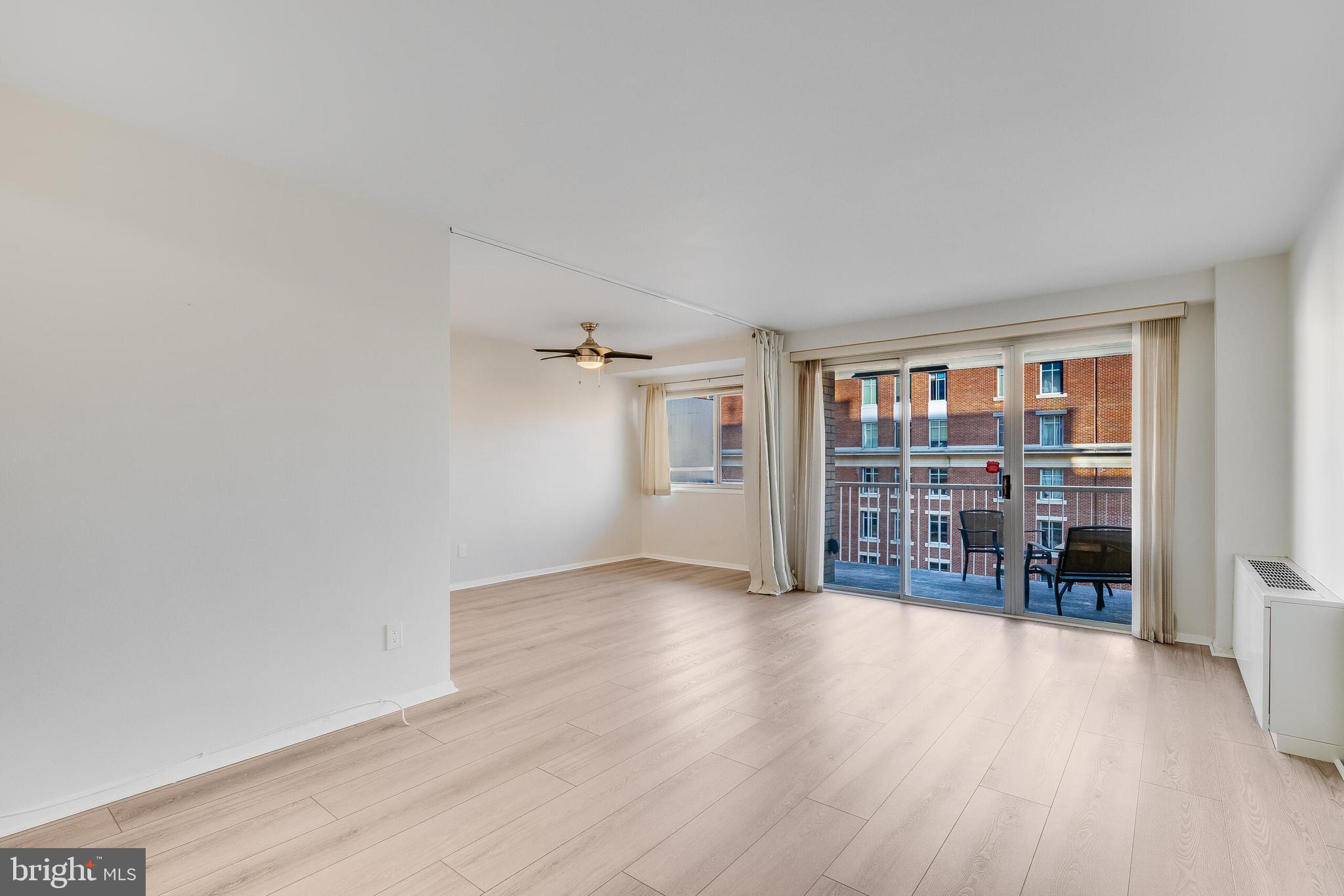 730 24th Street Northwest, Unit 708 Washington, DC 20037 - Photo 11 of 41 an empty room with wooden floor and windows