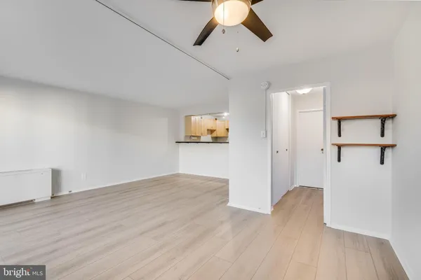 a view of a room with wooden floor closet and windows