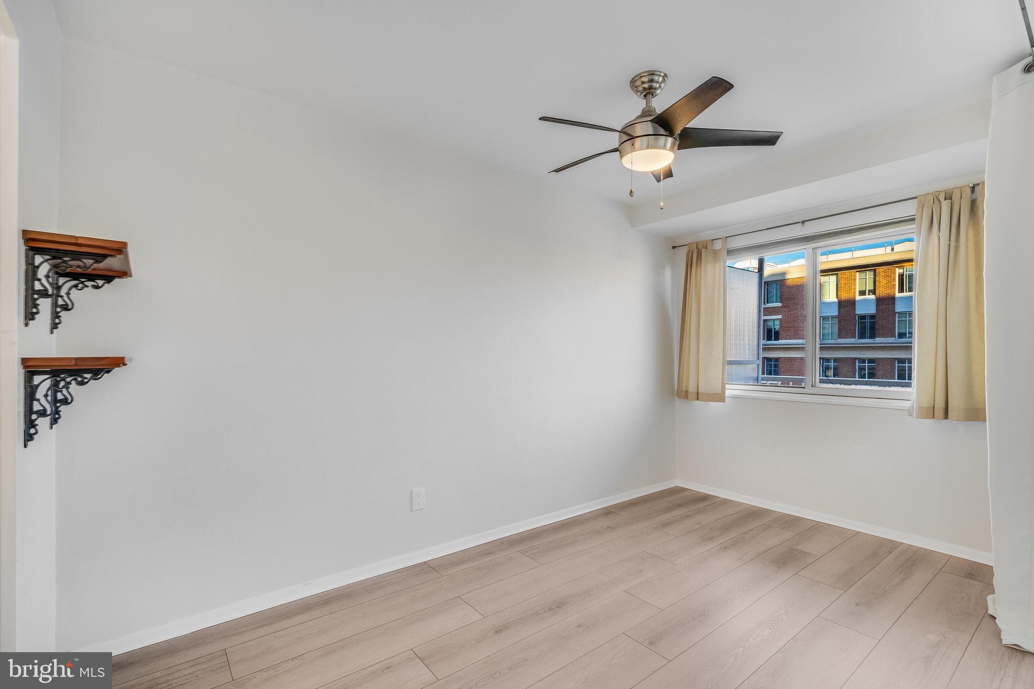 730 24th Street Northwest, Unit 708 Washington, DC 20037 - Photo 19 of 41 a view of empty room with wooden floor and fan