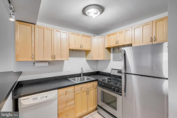 a kitchen with stainless steel appliances granite countertop a refrigerator sink and cabinets