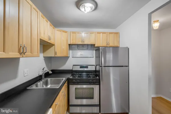a kitchen with a stove a sink and a refrigerator