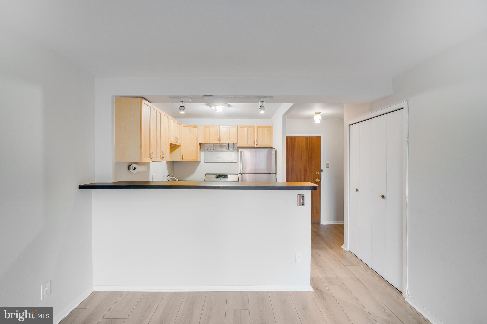 730 24th Street Northwest, Unit 708 Washington, DC 20037 - Photo 23 of 41 a kitchen with stainless steel appliances a refrigerator and a stove top oven