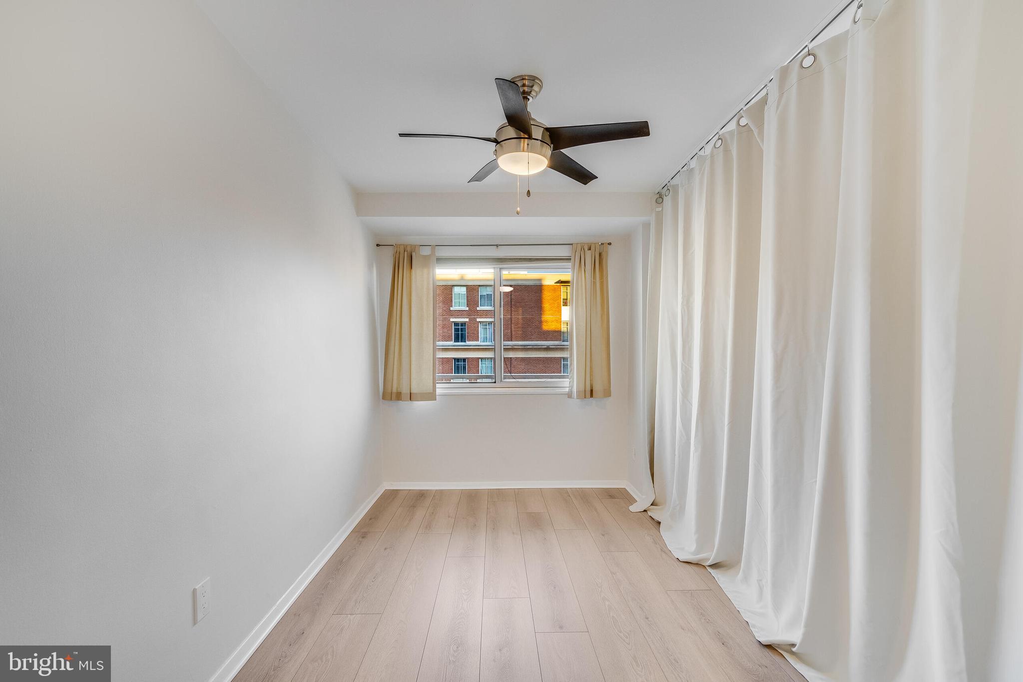 730 24th Street Northwest, Unit 708 Washington, DC 20037 - Photo 29 of 41 wooden floor in an empty room with a window