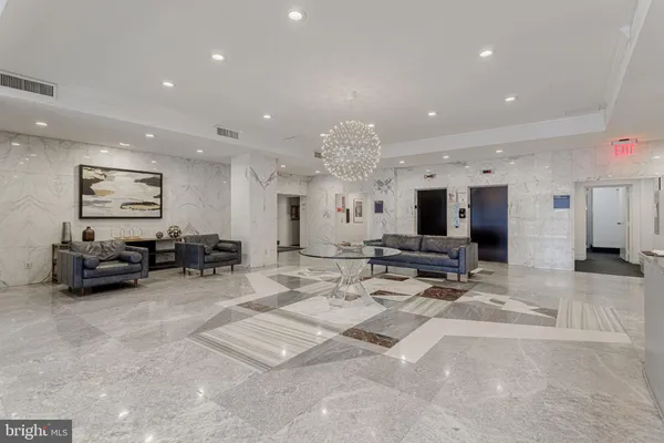 a living room with furniture a large window and flat screen tv
