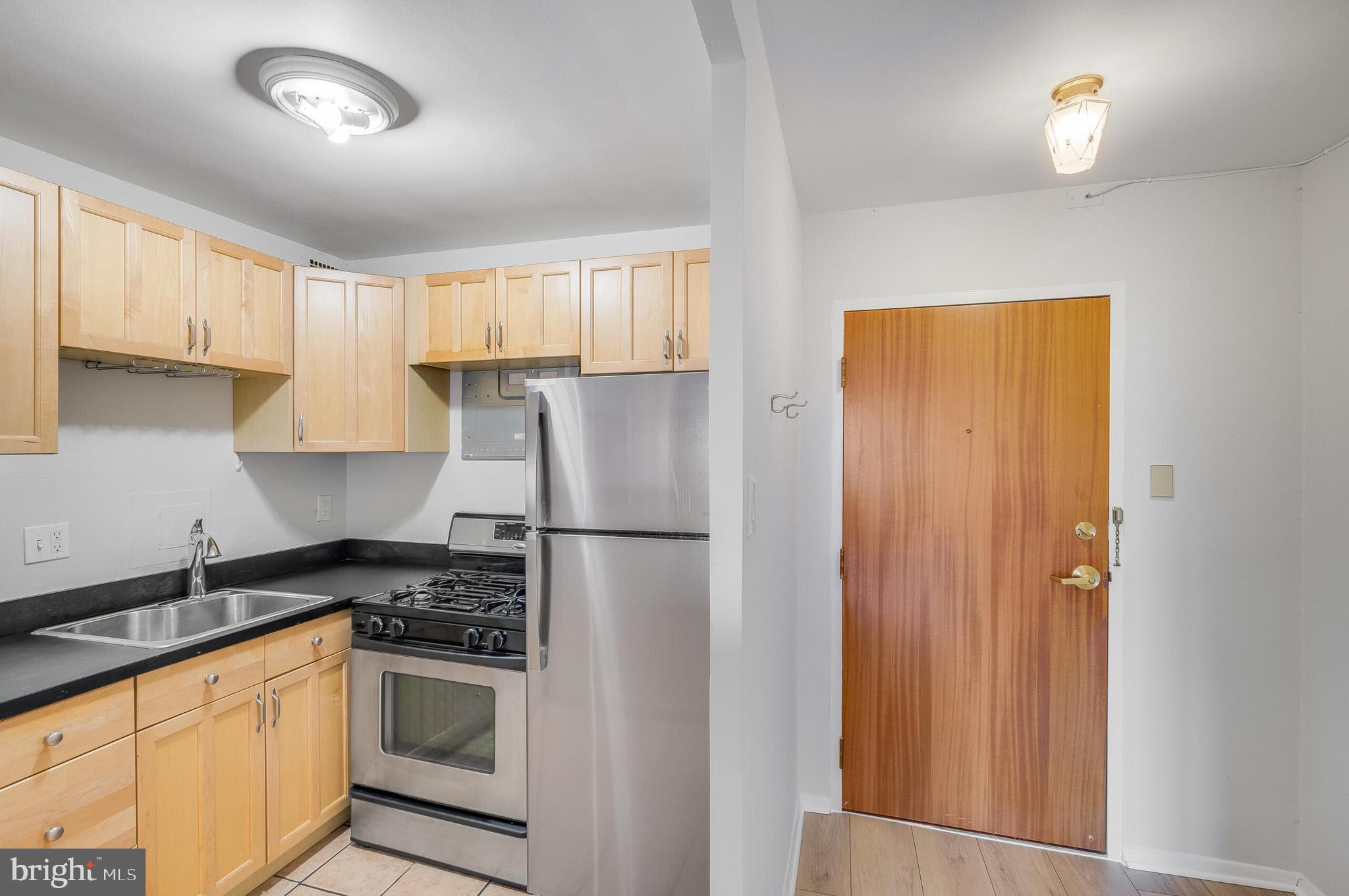 730 24th Street Northwest, Unit 708 Washington, DC 20037 - Photo 7 of 41 a kitchen with a refrigerator a stove a sink and cabinets
