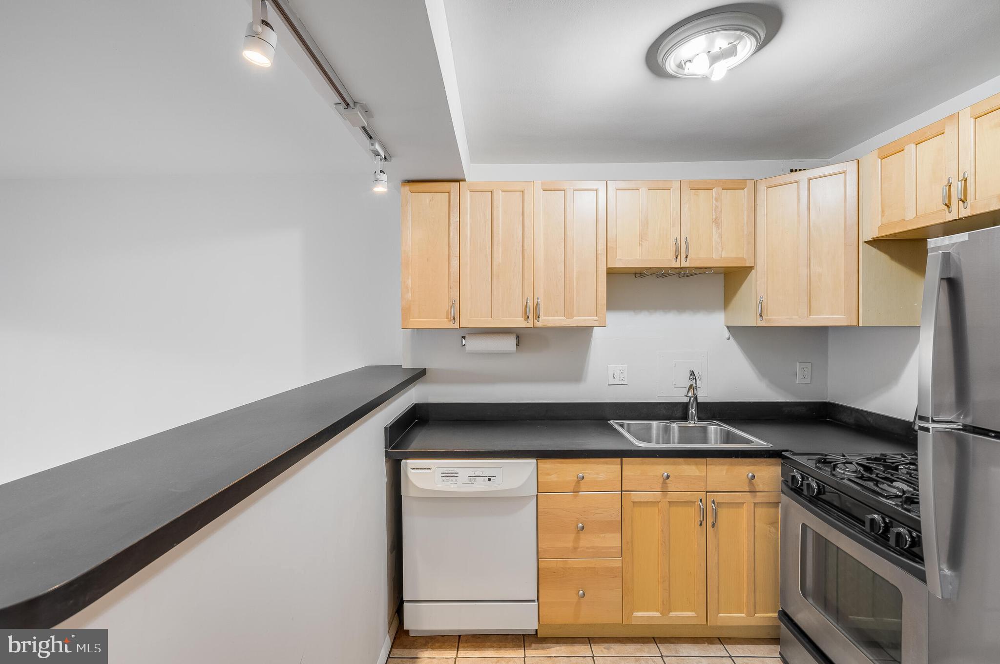 730 24th Street Northwest, Unit 708 Washington, DC 20037 - Photo 8 of 41 a kitchen with granite countertop a stove and cabinets