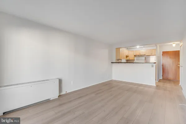 a view of a kitchen with a sink and a refrigerator