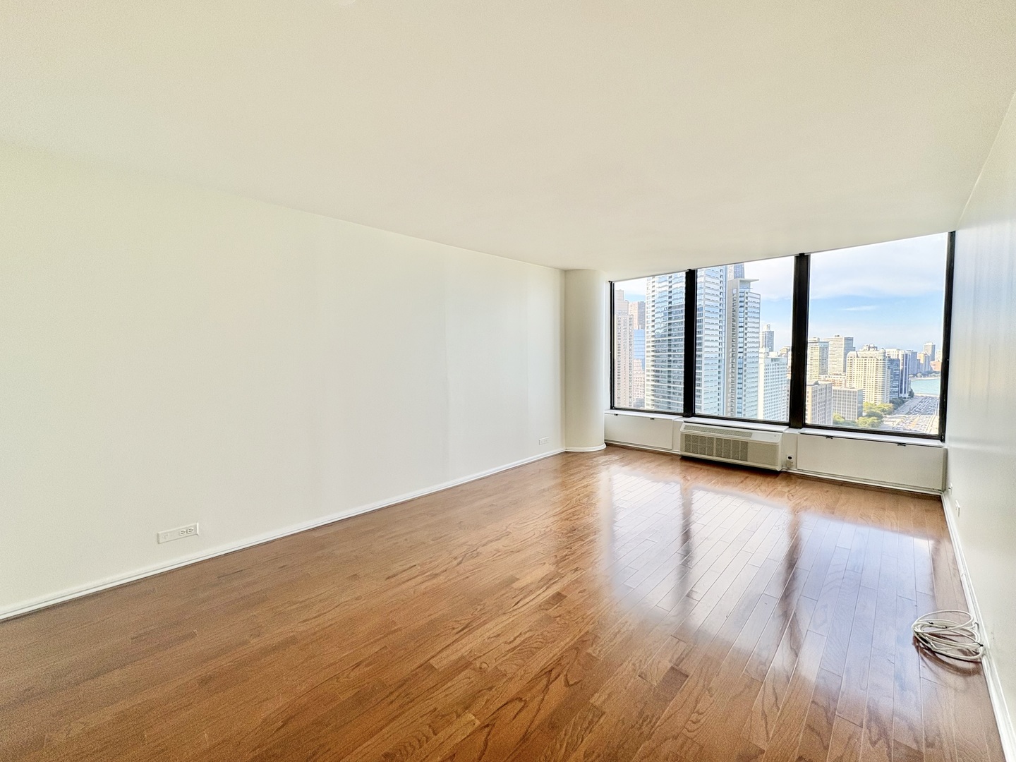 505 North Lake Shore Drive, Unit 3312 Chicago, IL 60611 - Photo 14 of 35 an empty room with wooden floor and windows