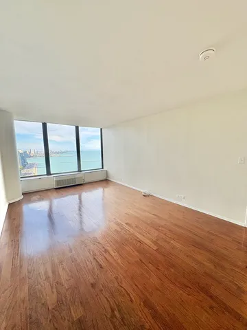 a view of an empty room and wooden floor