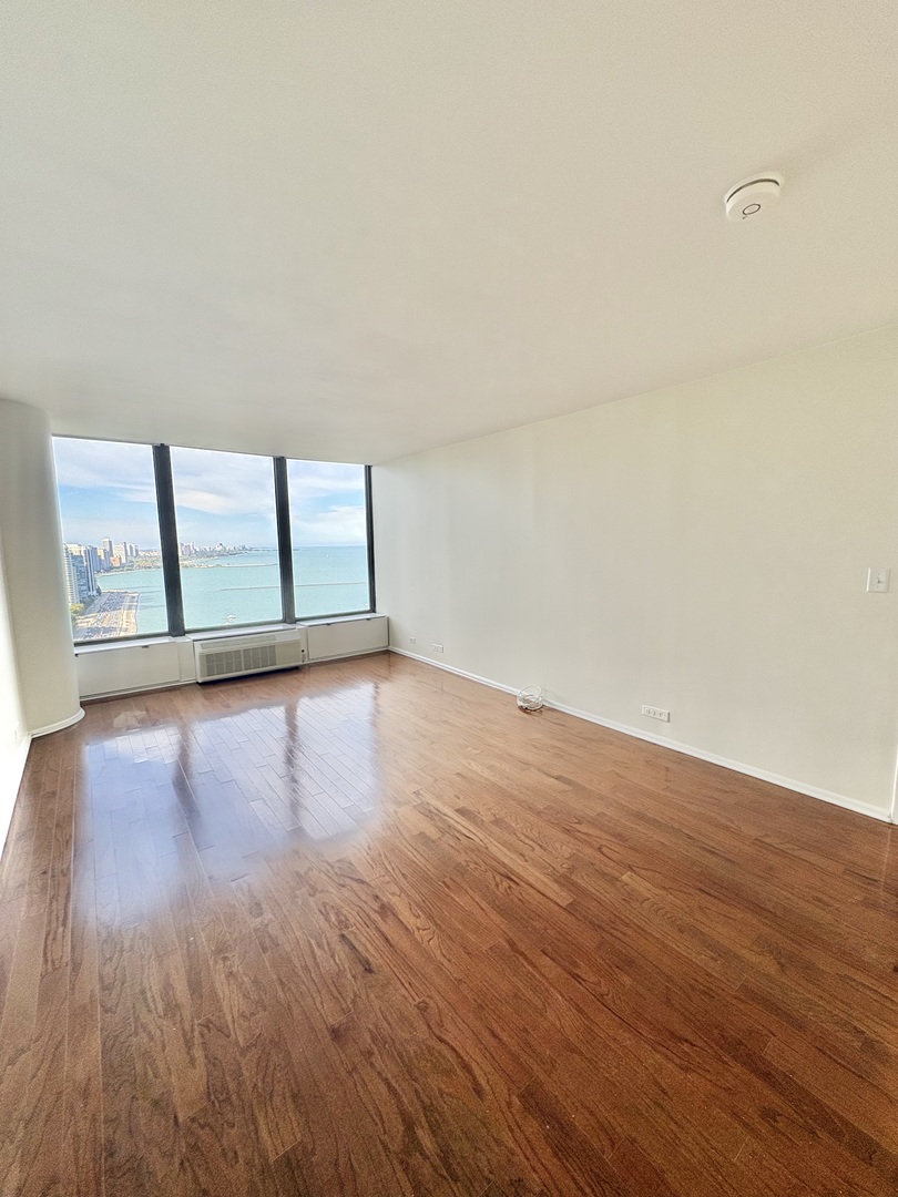 505 North Lake Shore Drive, Unit 3312 Chicago, IL 60611 - Photo 15 of 35 an empty room with wooden floor and windows