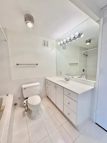 a bathroom with a bathtub a toilet and a shower