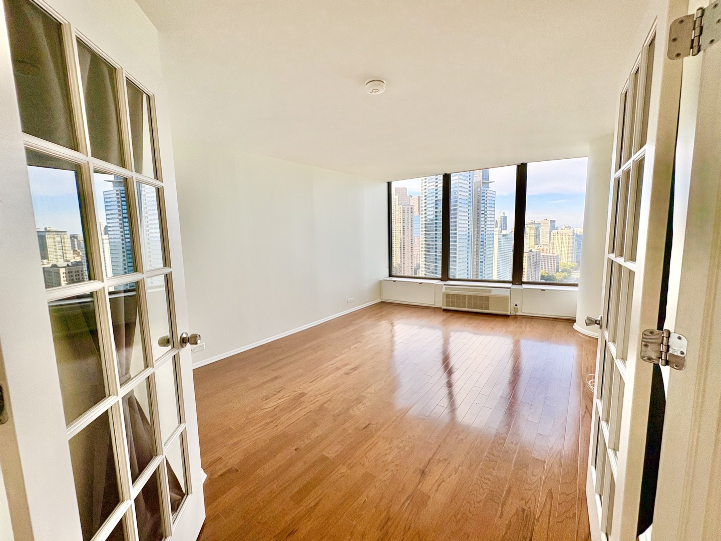 505 North Lake Shore Drive, Unit 3312 Chicago, IL 60611 - Photo 21 of 35 a view of an empty room with wooden floor and a window