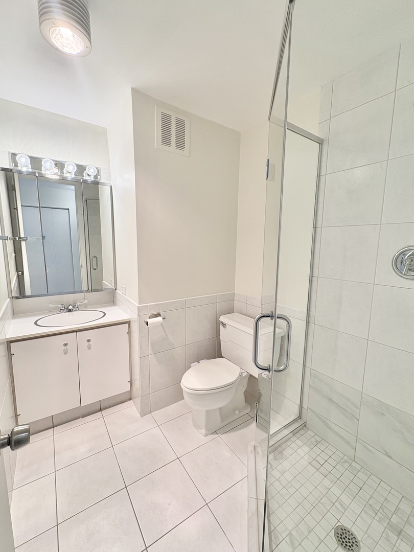 505 North Lake Shore Drive, Unit 3312 Chicago, IL 60611 - Photo 22 of 35 a bathroom with a sink toilet and shower