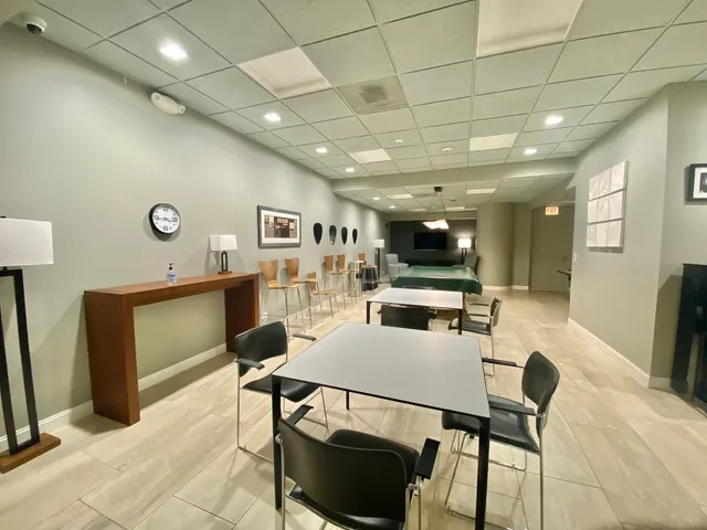 a living room with furniture a rug and a large window
