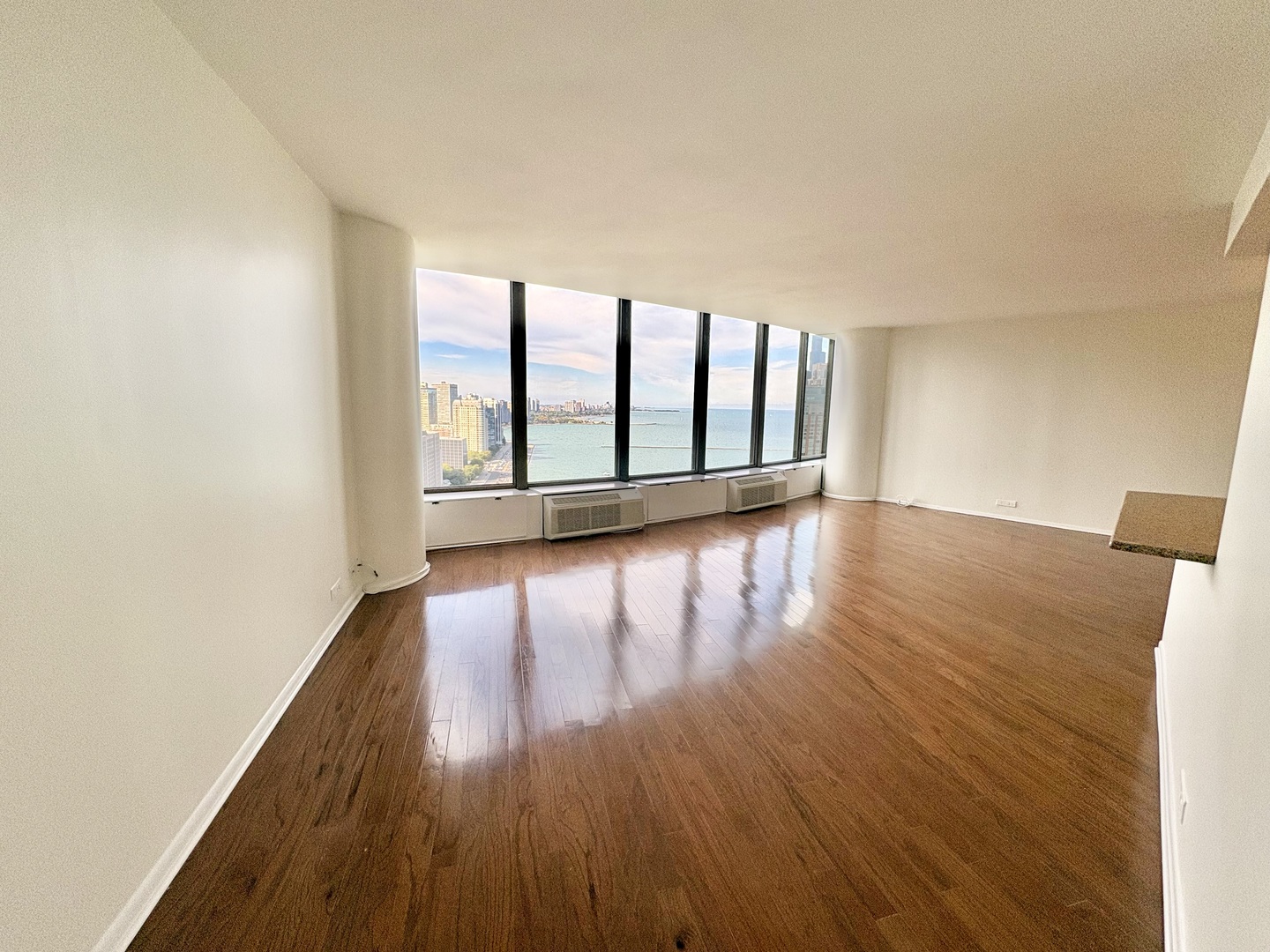 505 North Lake Shore Drive, Unit 3312 Chicago, IL 60611 - Photo 4 of 35 a view of an empty room with wooden floor and a window