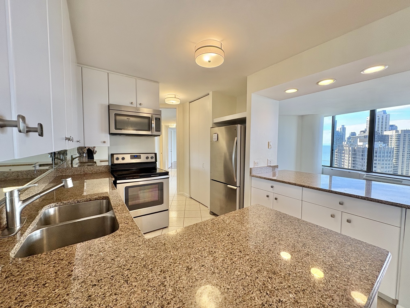 505 North Lake Shore Drive, Unit 3312 Chicago, IL 60611 - Photo 9 of 35 a kitchen with stainless steel appliances a refrigerator sink and microwave
