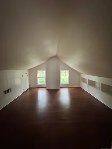 a view of an empty room and wooden floor
