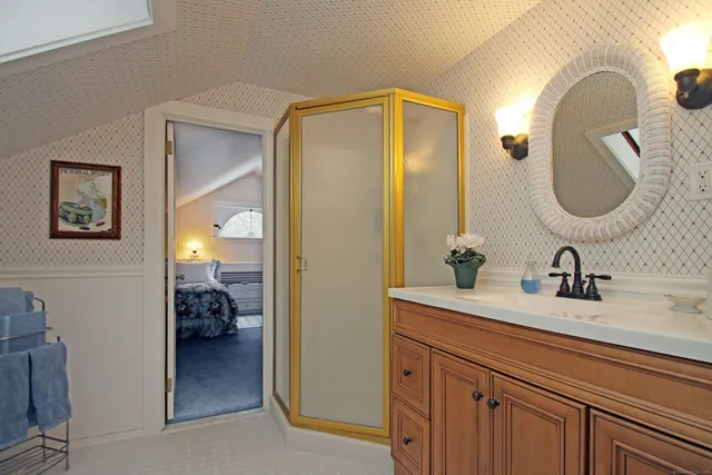 a spacious bathroom with a toilet sink shower and mirror