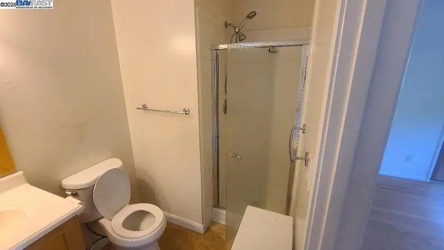 a white toilet sitting next to a bathroom sink