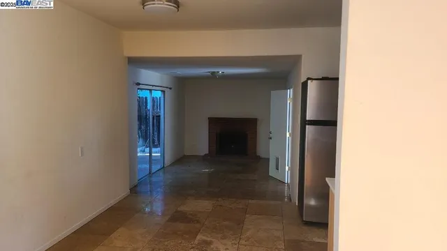 a view of a hallway with wooden shelves