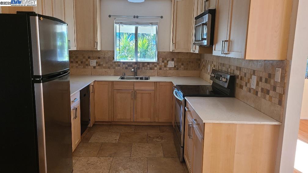 1501 L Street Davis, CA 95616 - Photo 8 of 23 a kitchen with a sink stove and refrigerator