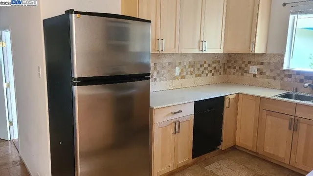 a kitchen with metallic refrigerator freezer and a dishwasher