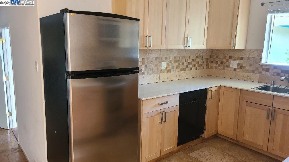 1501 L Street Davis, CA 95616 - Photo 9 of 23 a kitchen with metallic refrigerator freezer and a dishwasher