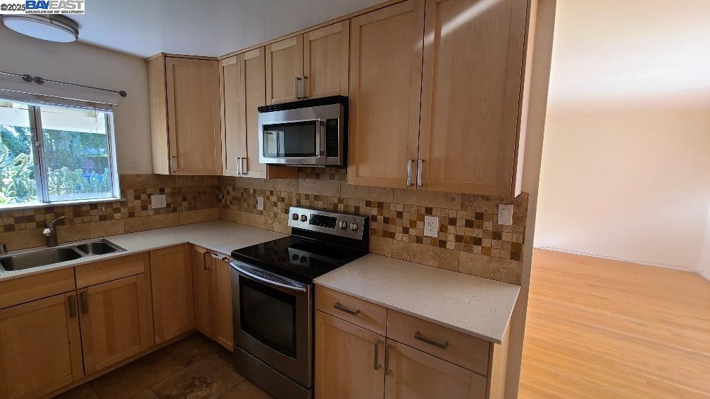 1501 L Street Davis, CA 95616 - Photo 10 of 23 a kitchen with a sink stove and microwave