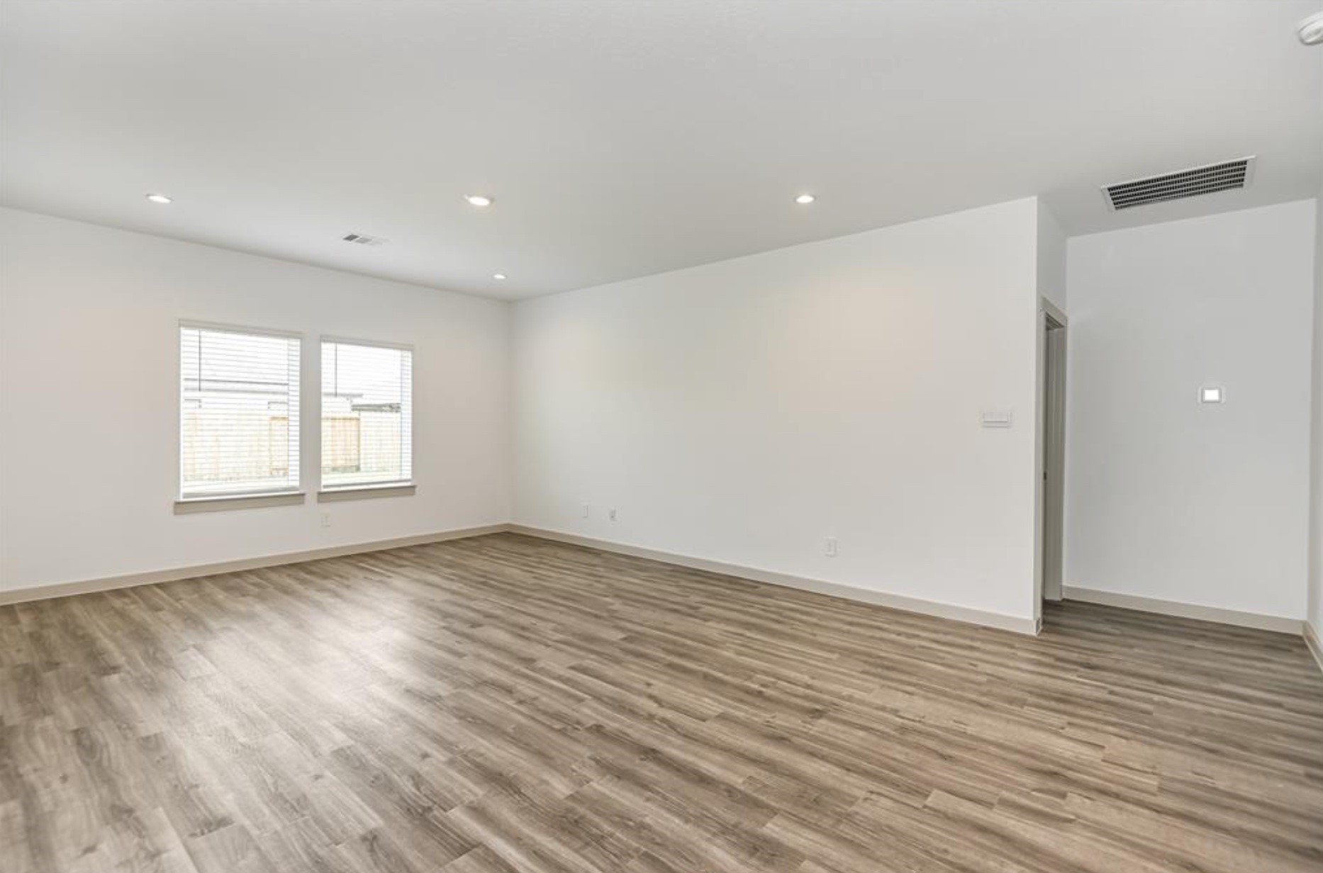 7918 Brumly Lane Rosharon, TX 77583 - Photo 11 of 34 a view of an empty room with wooden floor and a window