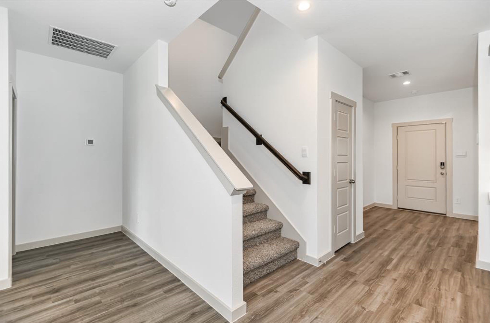 7918 Brumly Lane Rosharon, TX 77583 - Photo 12 of 34 a view of a hallway with wooden floor and staircase