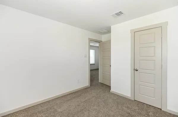 an empty room with closet area