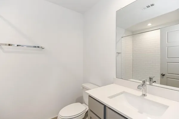 a bathroom with a sink toilet and vanity