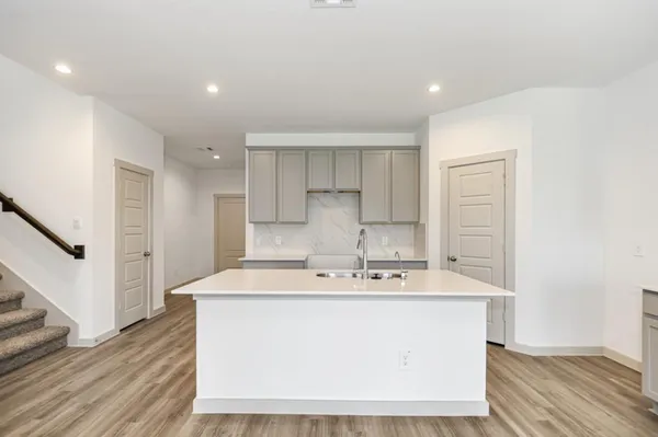 a view of kitchen with sink microwave and refrigerator